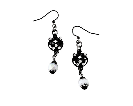 Black and white polka dot earrings with pearl-like beads on a white background