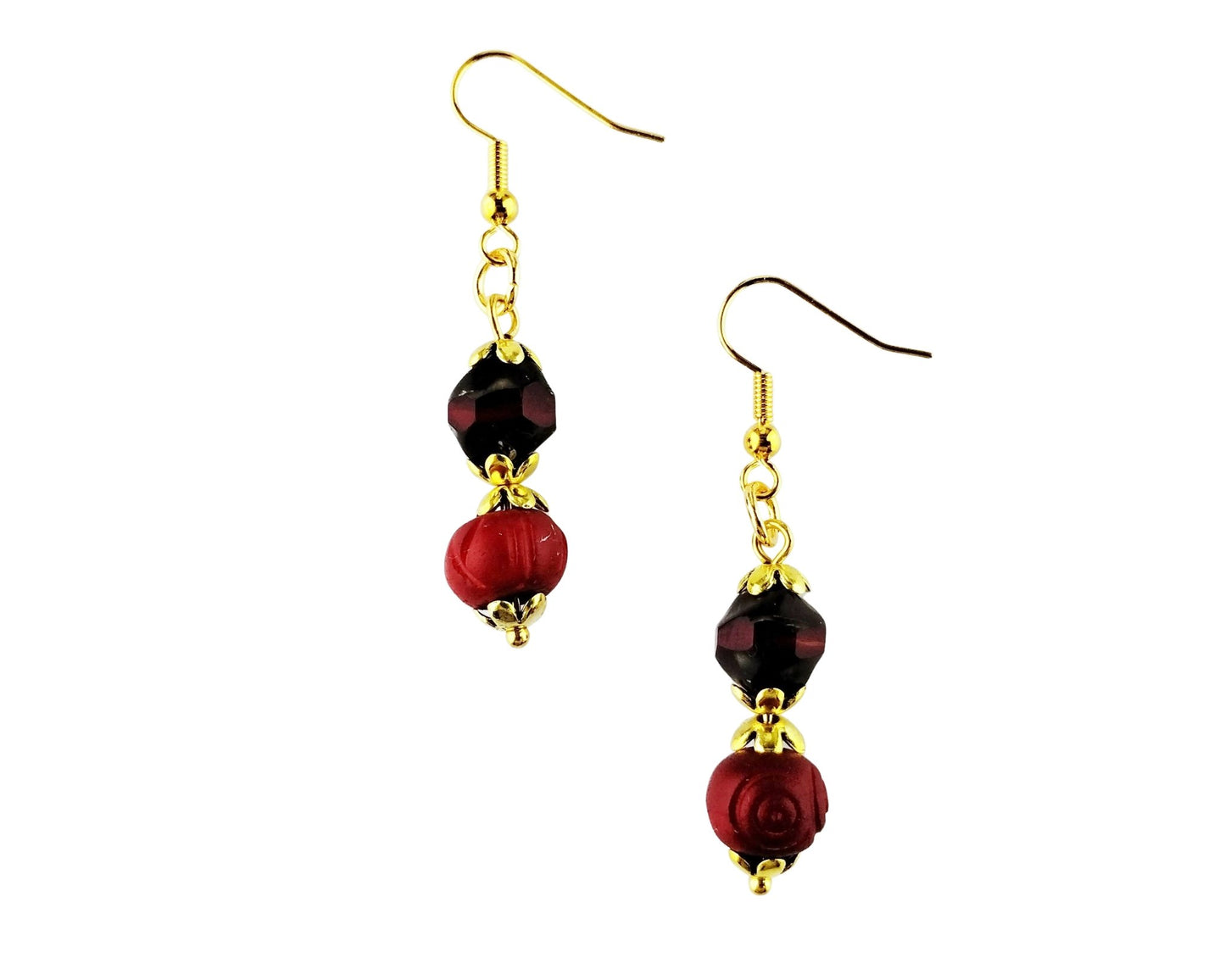 A pair of gold-tone dangle earrings featuring a faceted dark red bead and a larger textured red rose-shaped bead, shown against a plain white background.