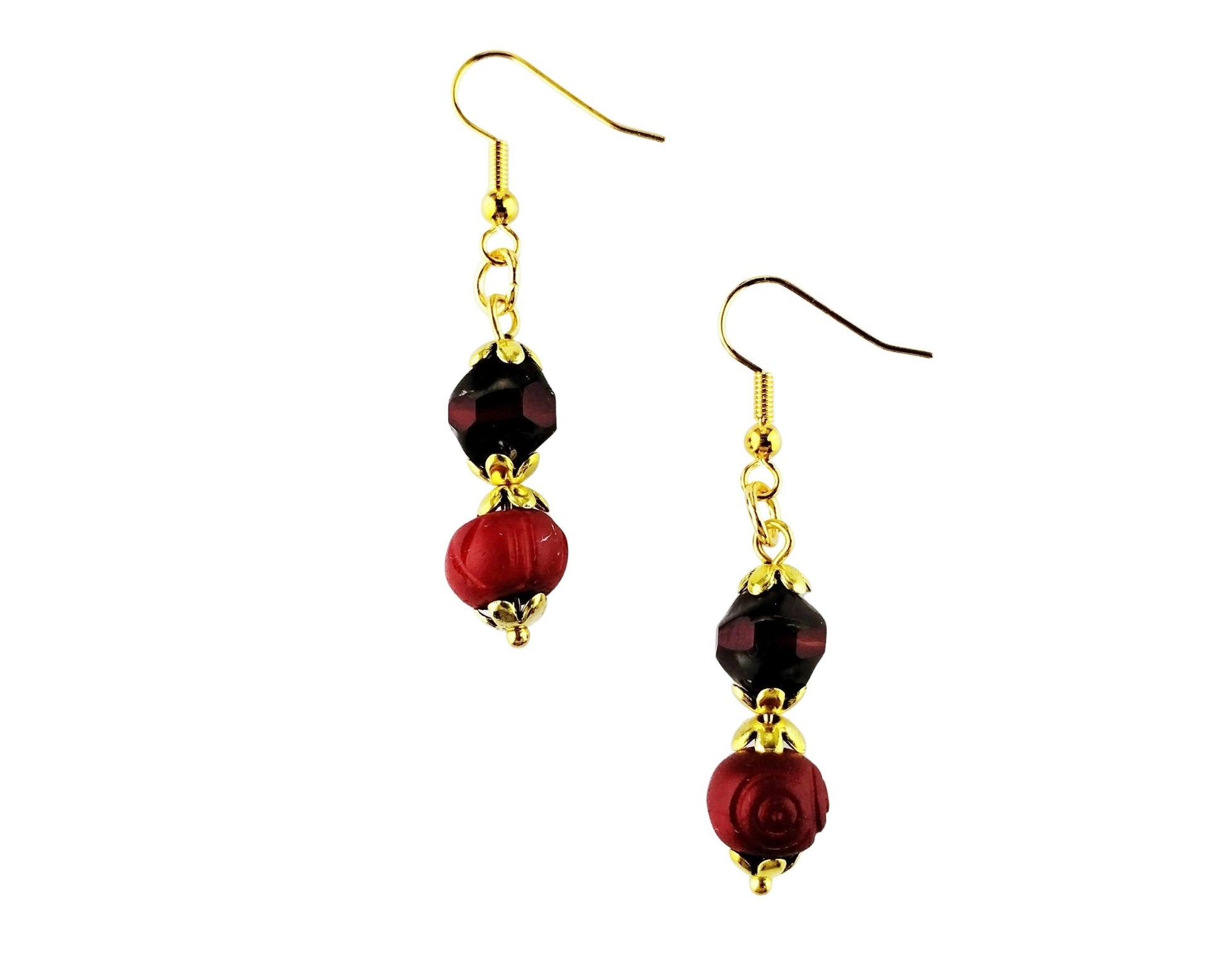 A pair of gold-tone dangle earrings featuring a faceted dark red bead and a larger textured red rose-shaped bead, shown against a plain white background.