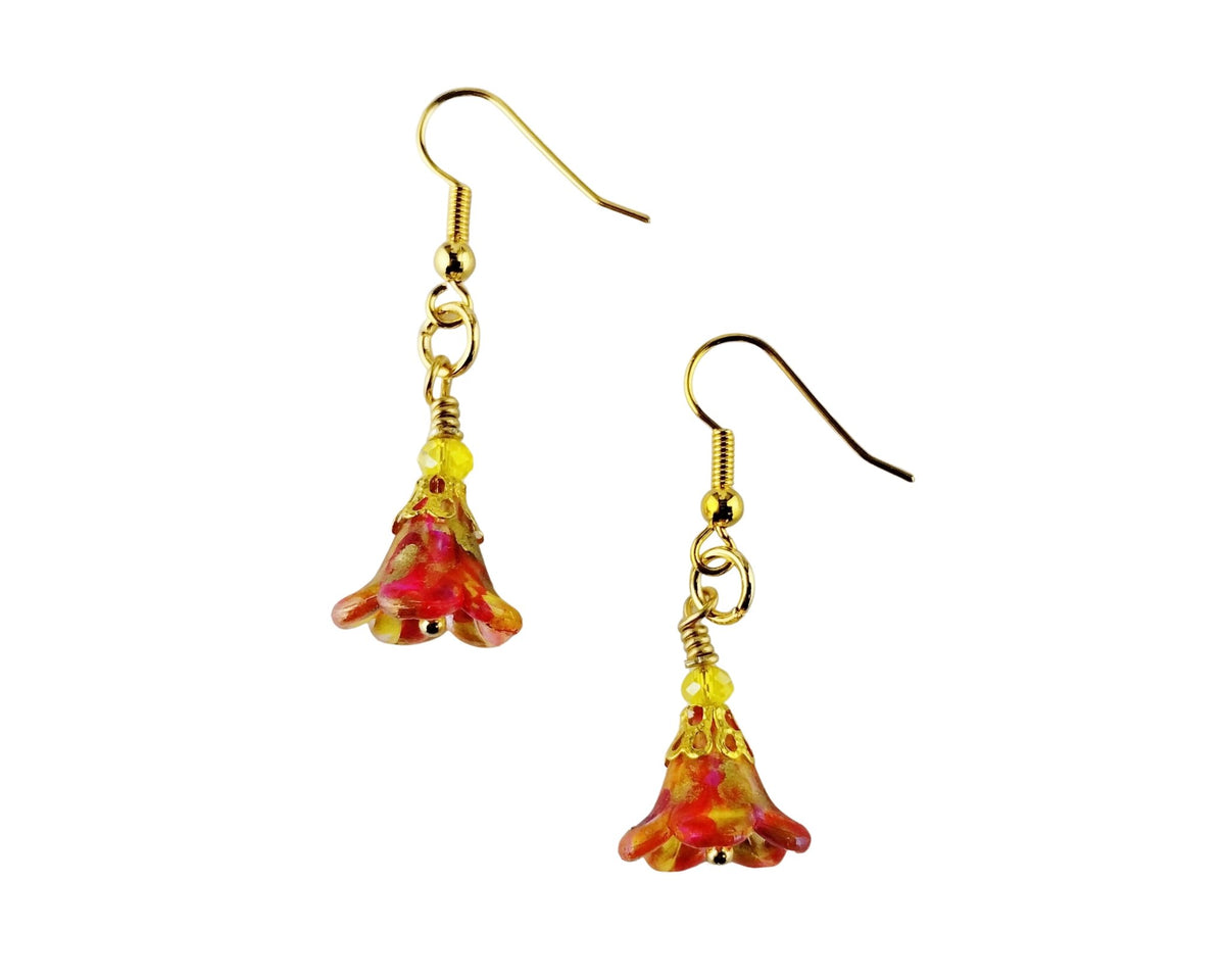 A pair of gold-tone dangle earrings with small yellow beads and translucent bell-shaped charms featuring a red and yellow marbled pattern, shown on a plain white background.