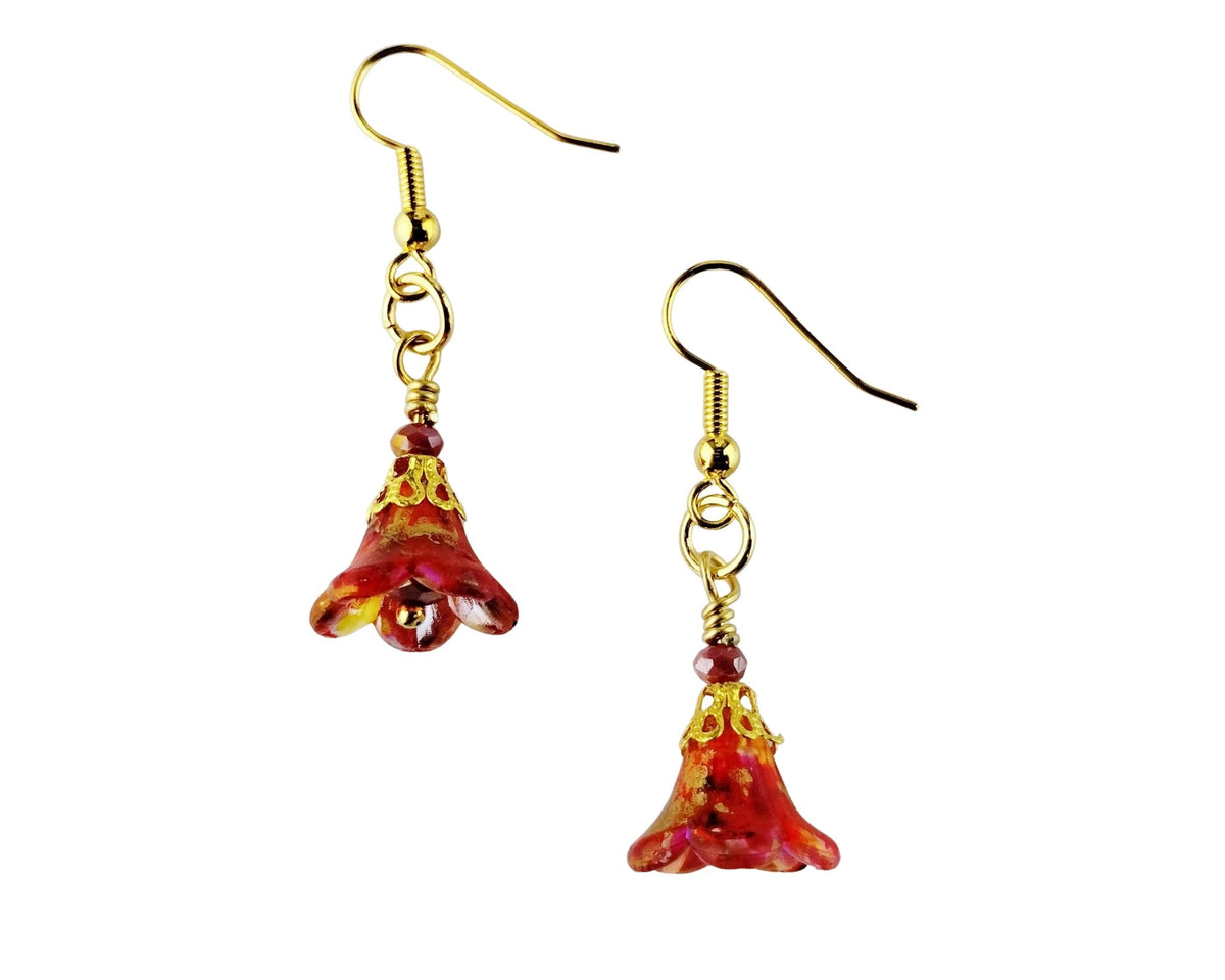A pair of dangling earrings with gold-tone fishhook wires and bell-shaped translucent red and orange glass flower charms, shown on a plain white background.