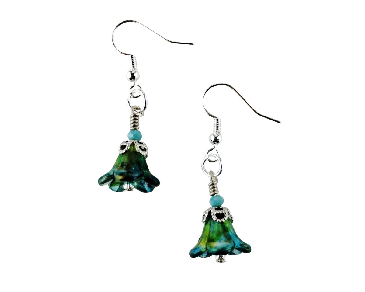 A pair of handmade dangle earrings featuring green and blue marbled glass bell-shaped charms with silver-tone metal hooks and turquoise beads, shown against a plain white background.