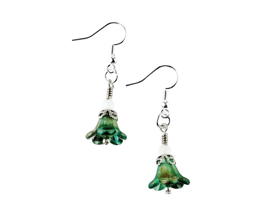 A pair of dangling earrings with green bell-shaped glass charms, silver-toned metal spacers, and silver fishhook ear wires, shown against a plain white background.