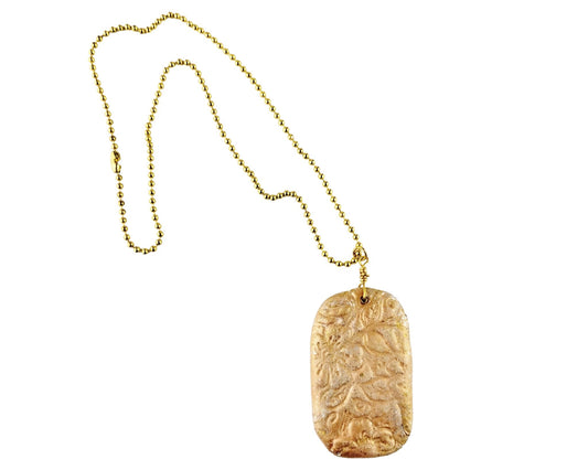 Handmade clay pendant necklace with stamped peach floral design
