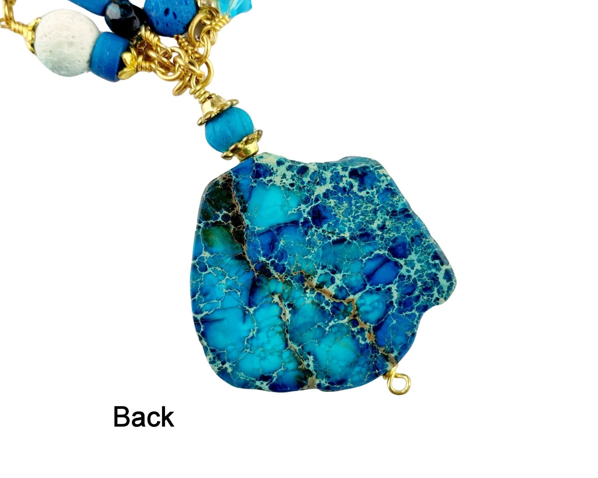 Back of gold-plated lobster clasp and extender chain on handcrafted necklace