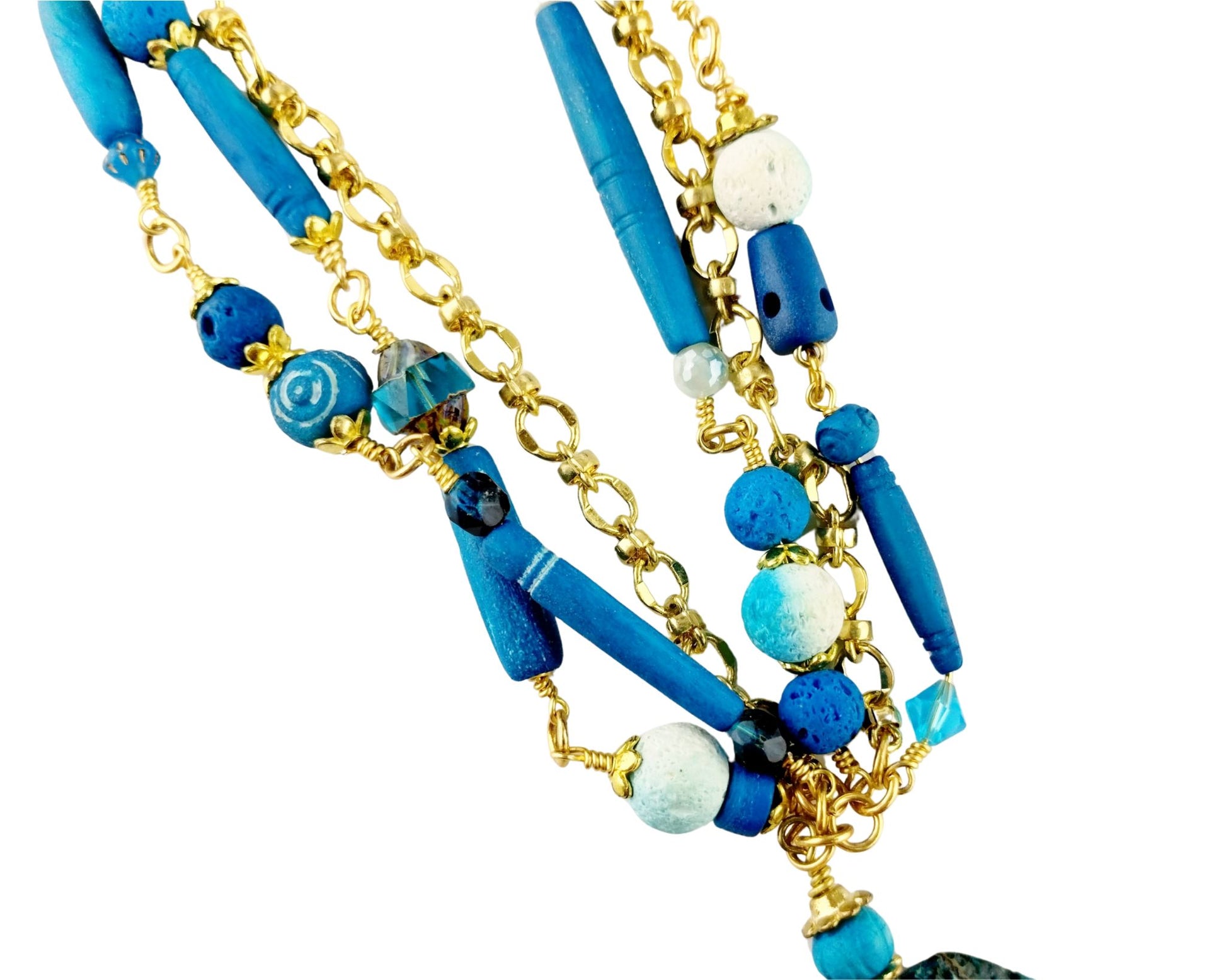 Close-up of dark aqua jasper pendant showing natural texture and shape

