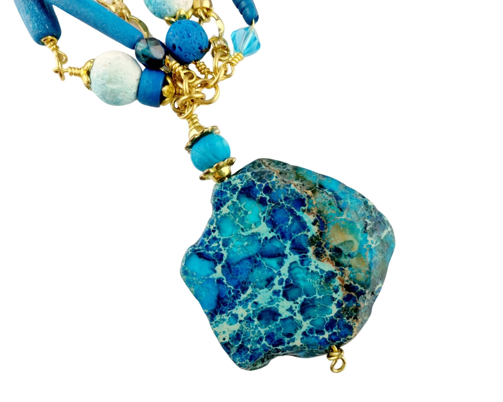 Close-up of dark aqua jasper pendant showing natural texture and shape

