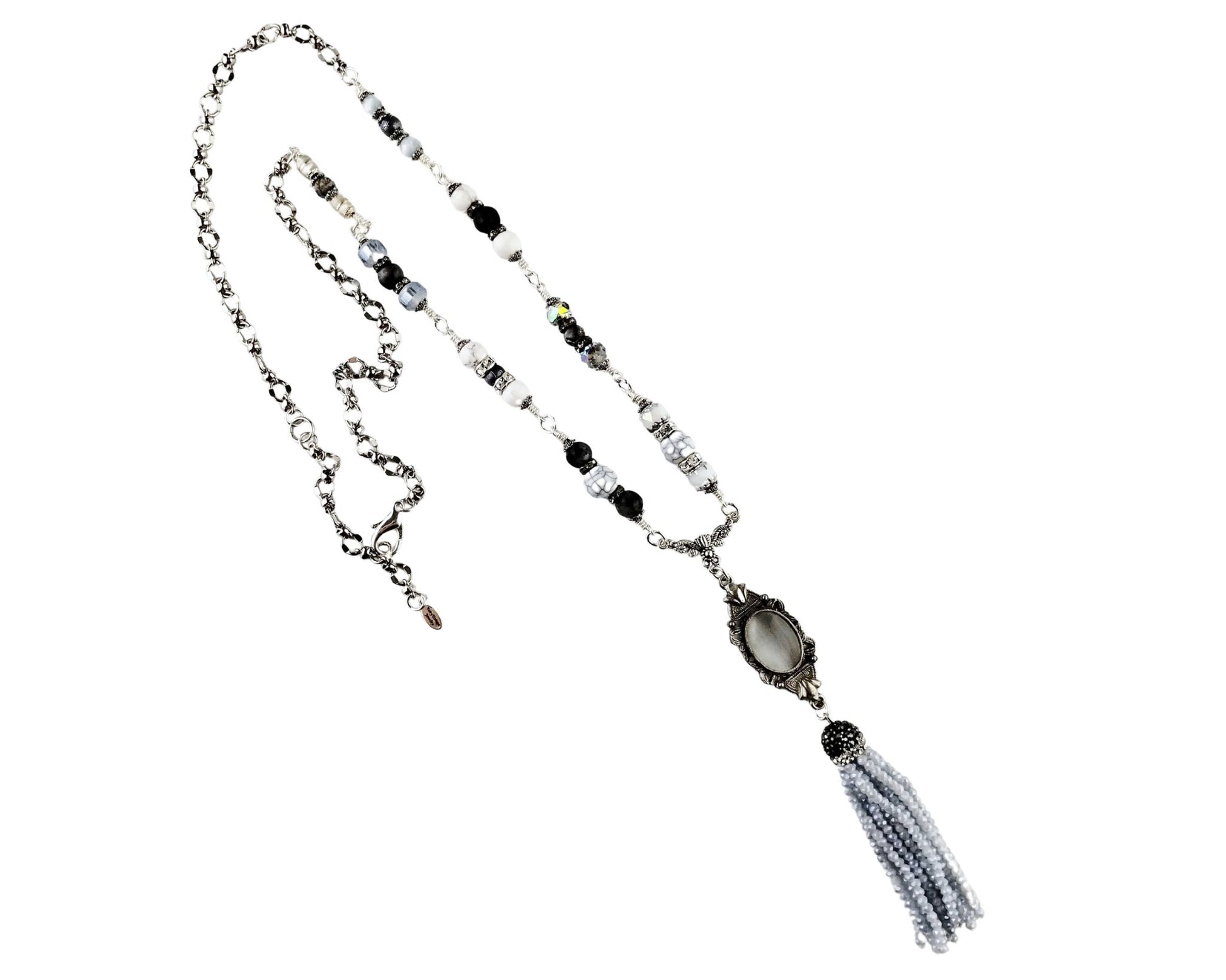 Handmade tassel pendant necklace with silver bezel and gray cat’s eye cabochon.