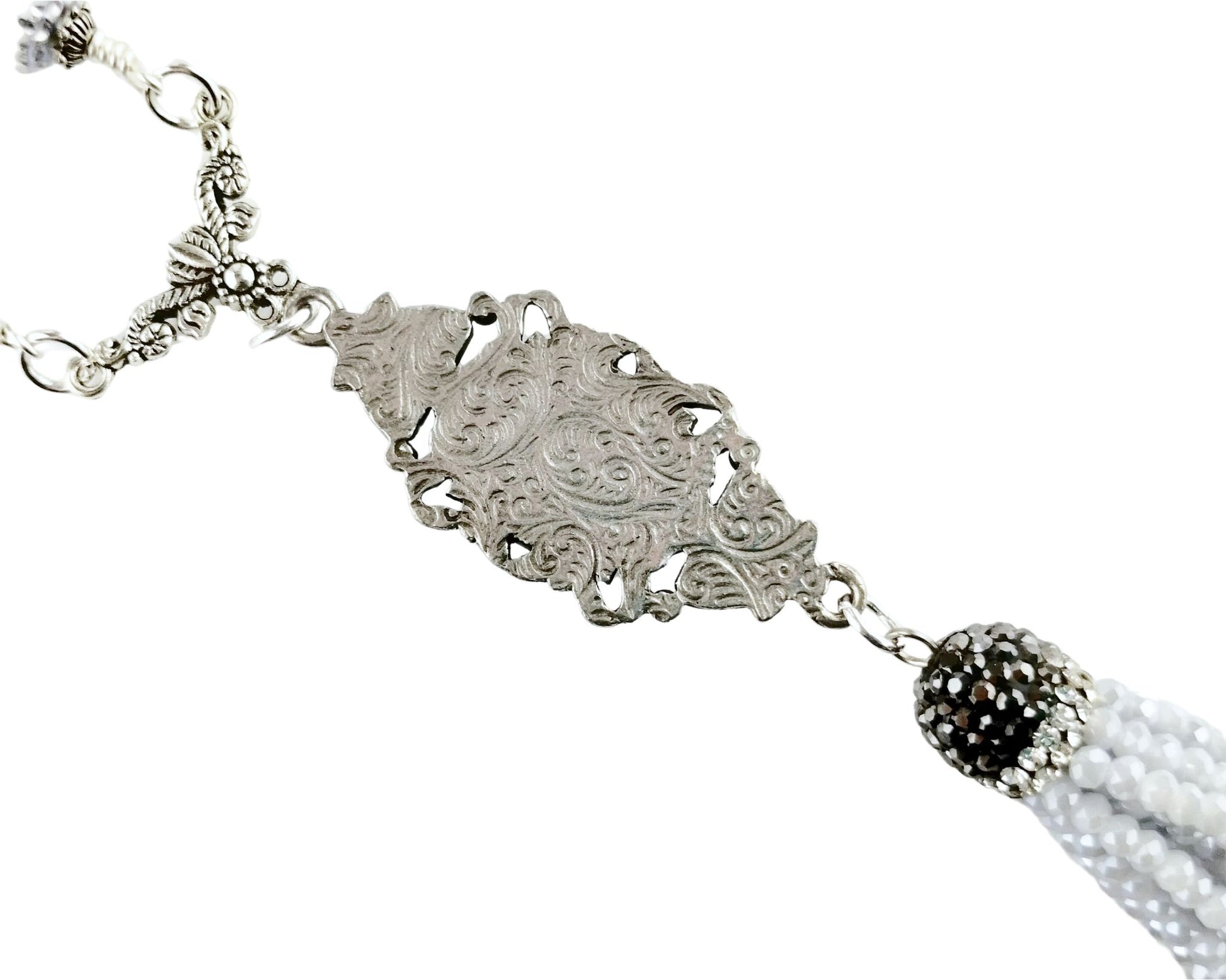 Back of Statement necklace featuring silver-plated chain, gray beads, and beaded tassel.
