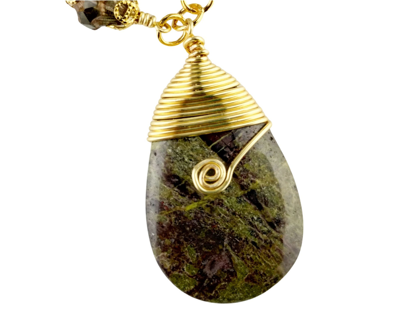 Close-up of serpentine pendant necklace with coordinating olive and eggplant beads.