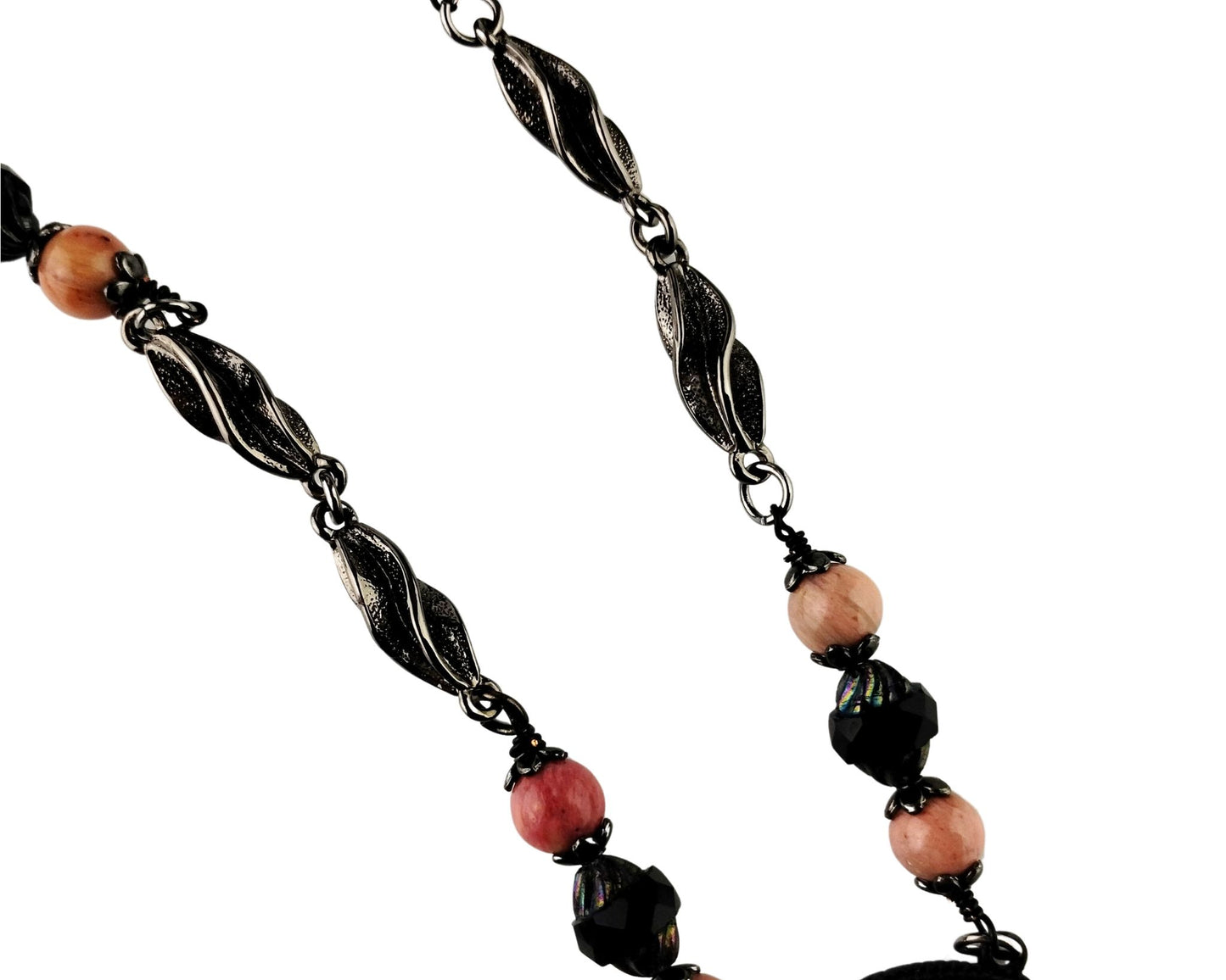 Close-up of large pink rhodonite pendant in matte black bezel