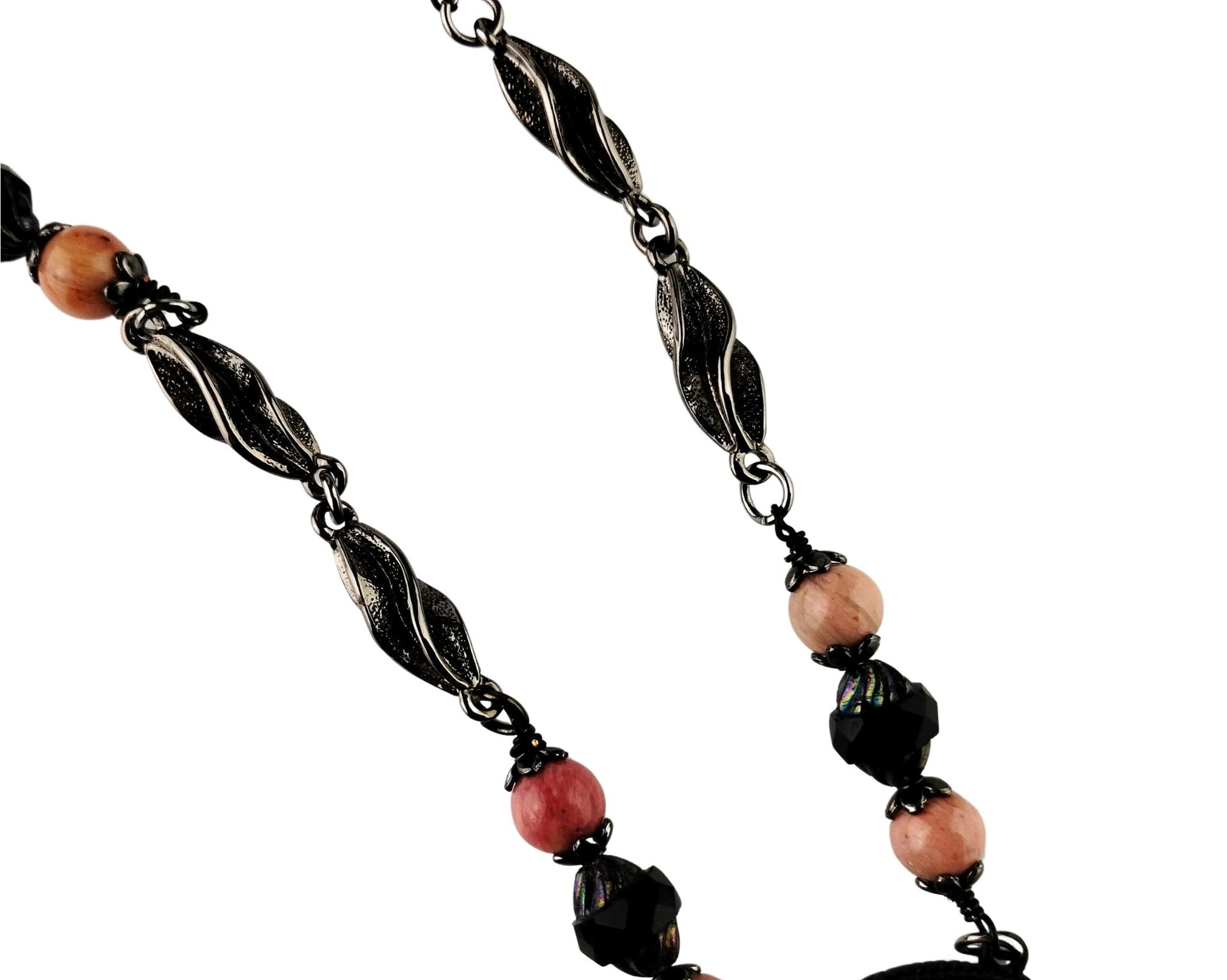 Close-up of large pink rhodonite pendant in matte black bezel