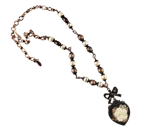 Handmade heart necklace with rusted iron bezel and ceramic rose