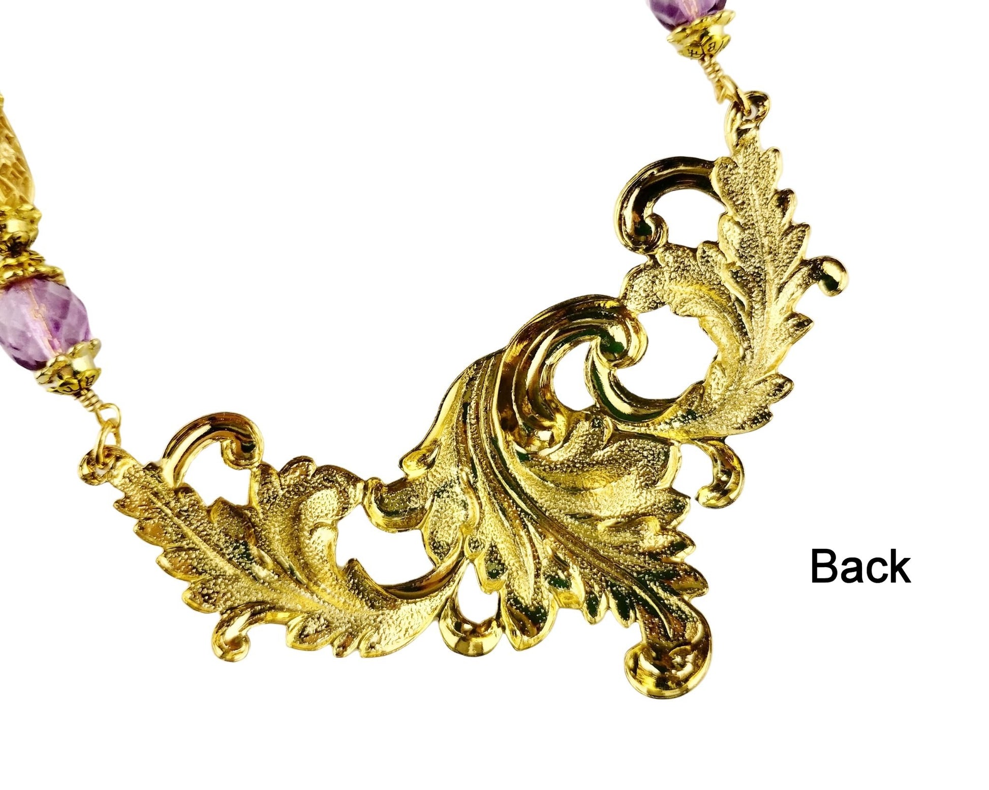Back of Handmade gold leaf swag necklace with purple beading


