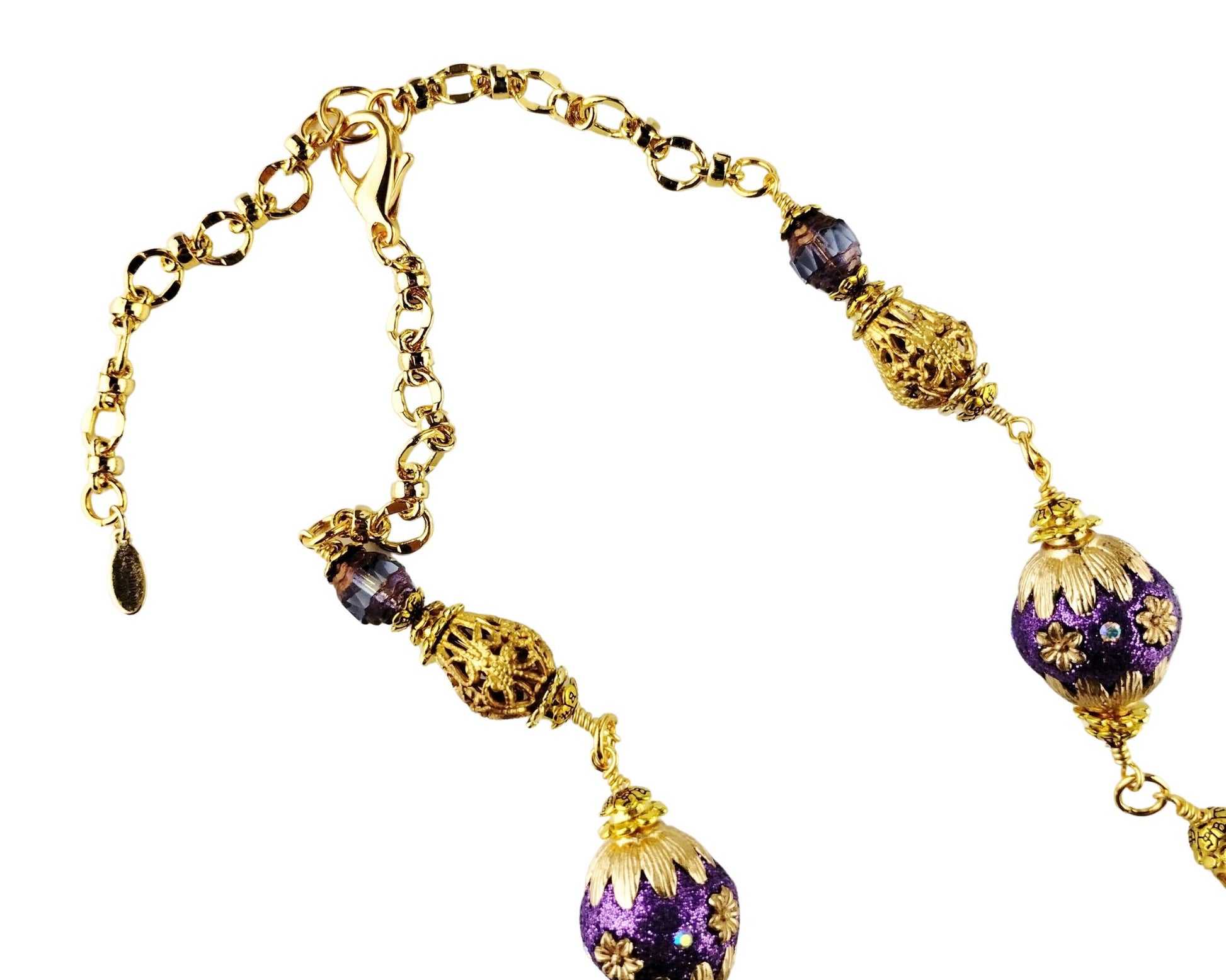 Purple and gold beaded necklace with leaf motif and filigree beads