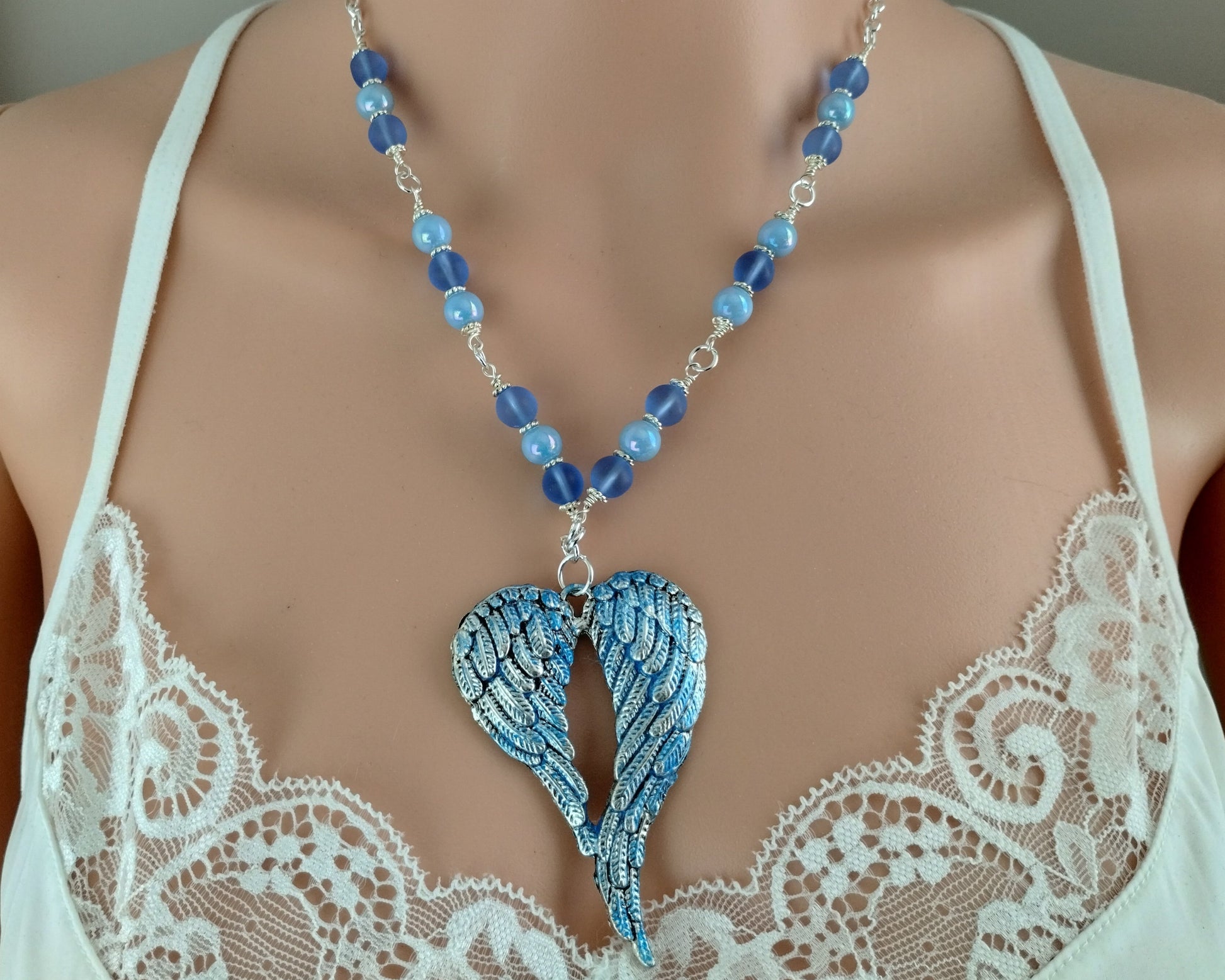 Celestial-inspired jewelry set with silver-plated wings and glass beads