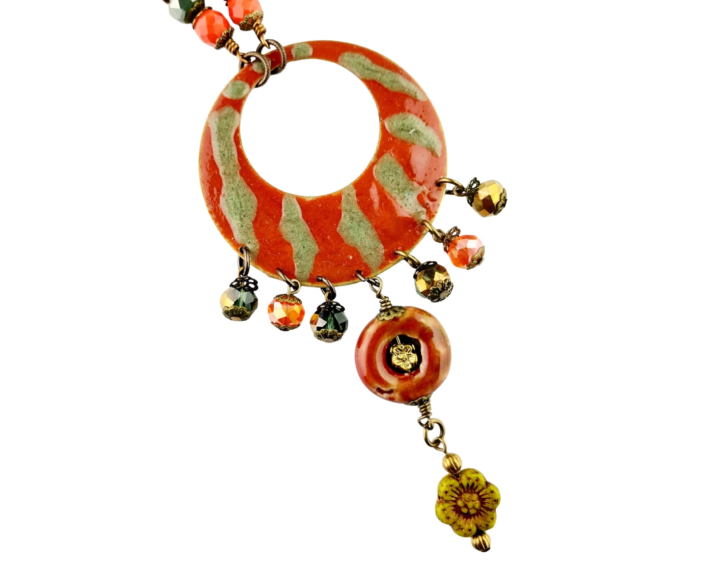 Necklace with orange and green circular pendant and dangling beads on a white background