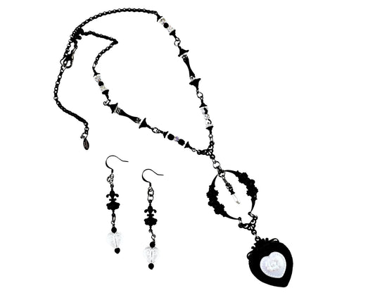 Black and white necklace and earrings set on a white background