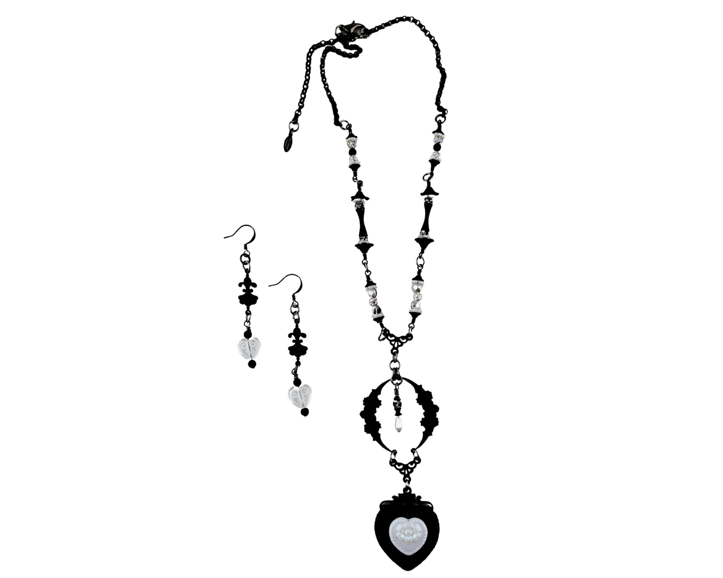 Black and white necklace and earrings set on a white background