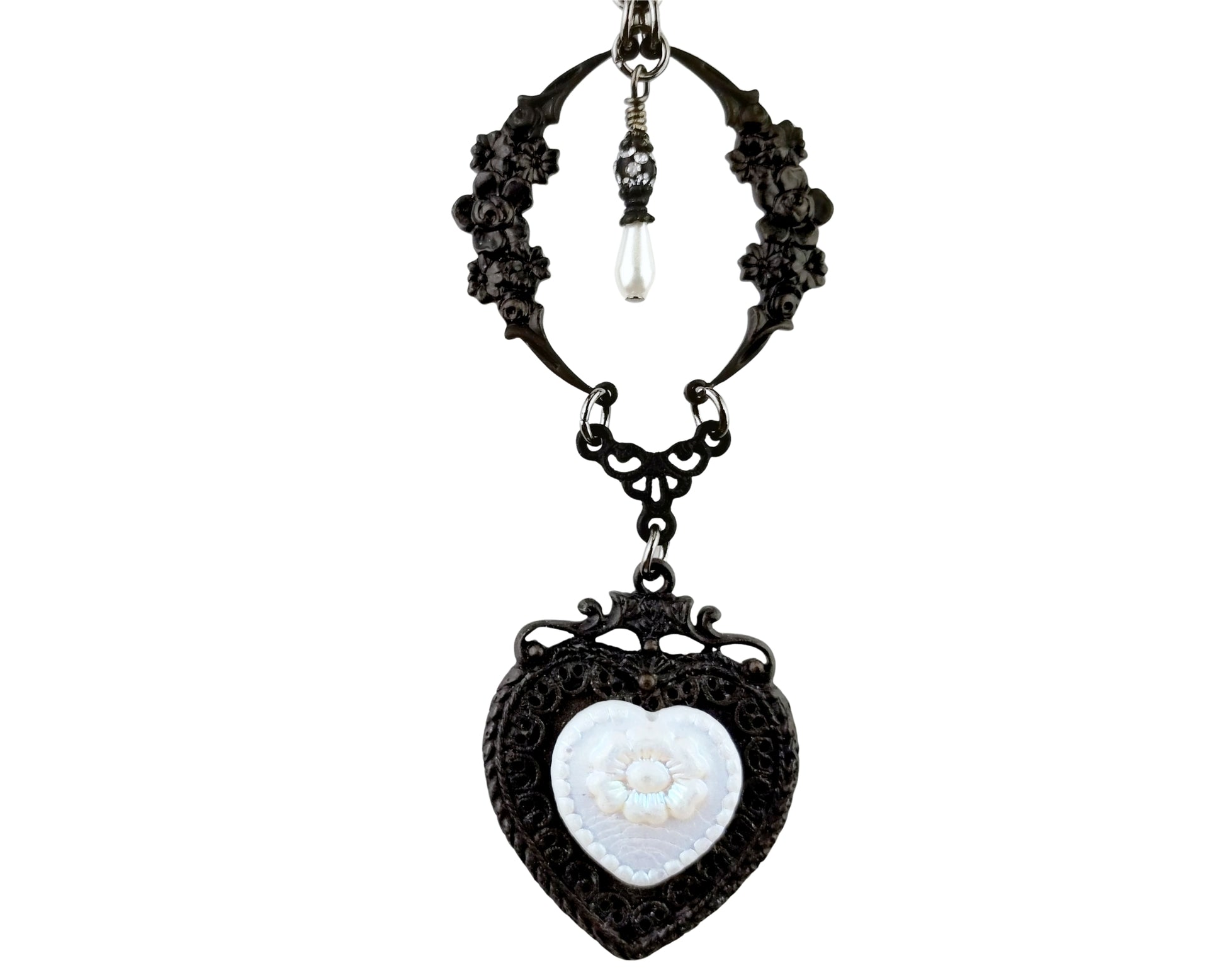 Black filigree necklace with a heart-shaped pendant on a white background