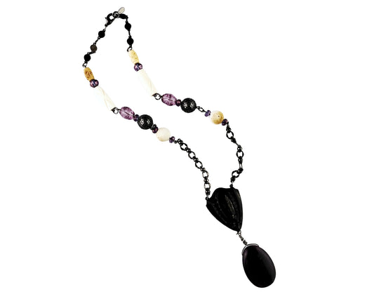 Necklace with Purple pendant and multicolored beads on a white background