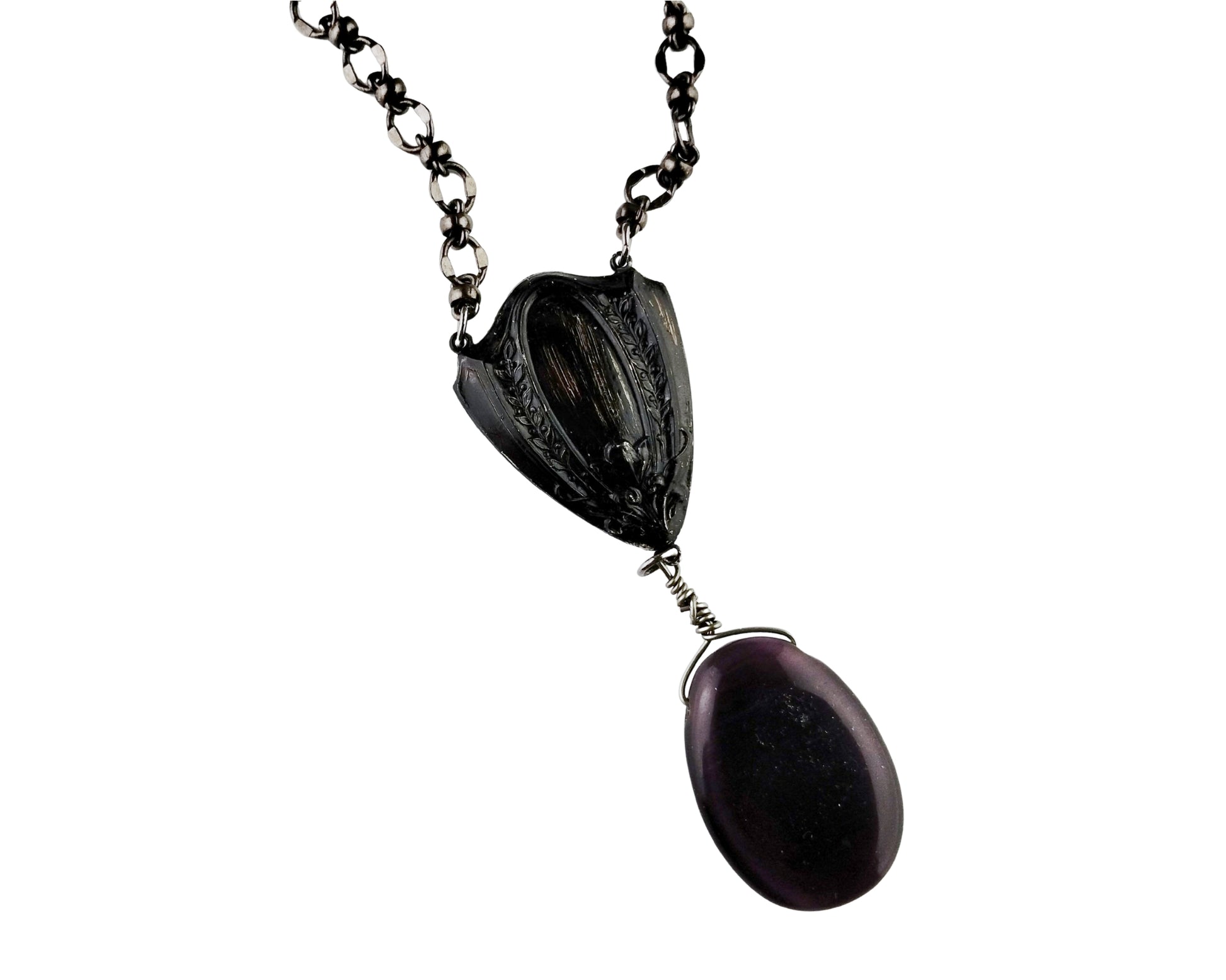Necklace with black pendant and purple stone on a white background
