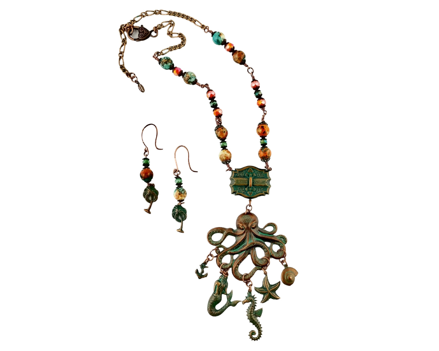Jewelry set with necklace and earrings featuring green and brown tones on a white background
