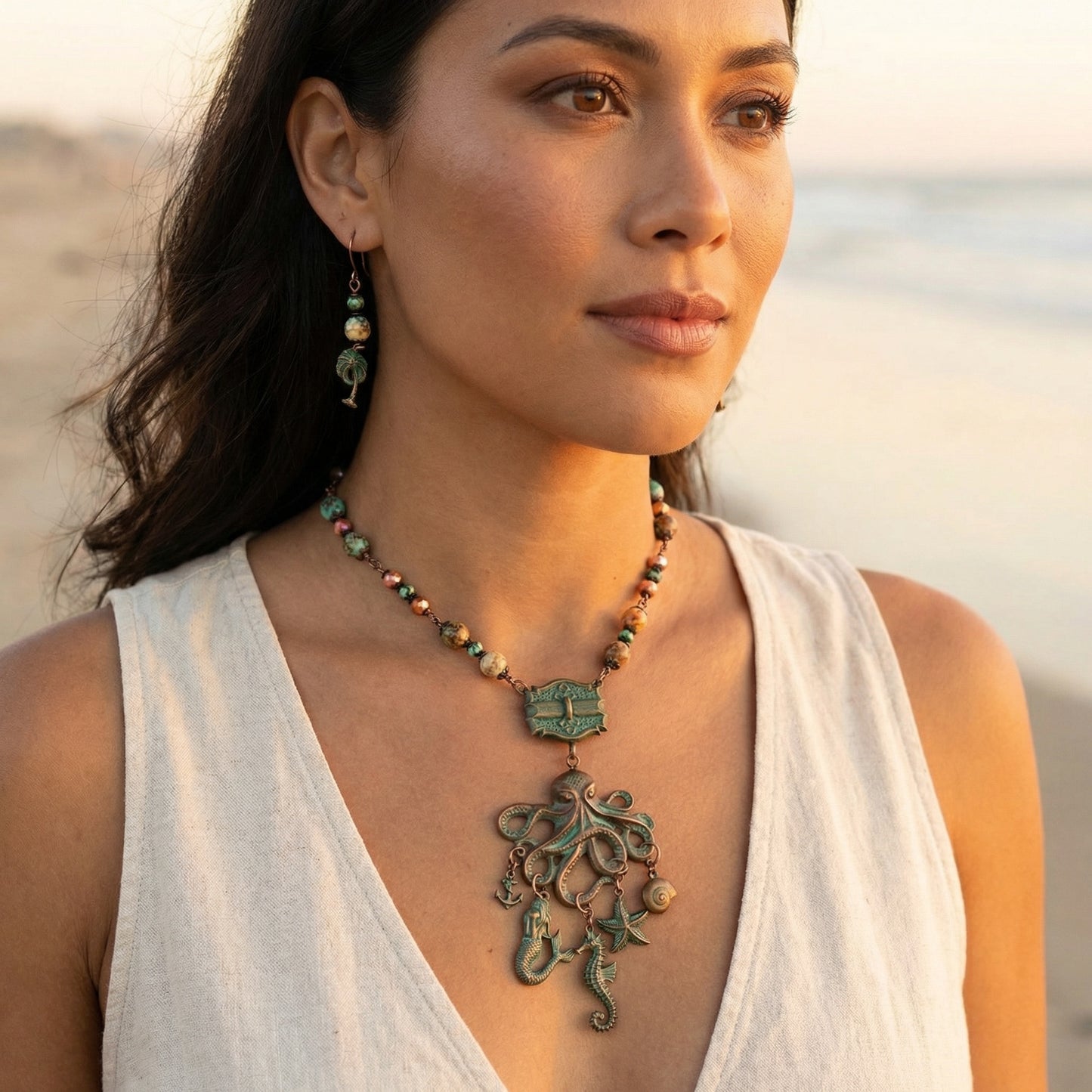 Woman wearing a necklace with a octopus pendant on a beach