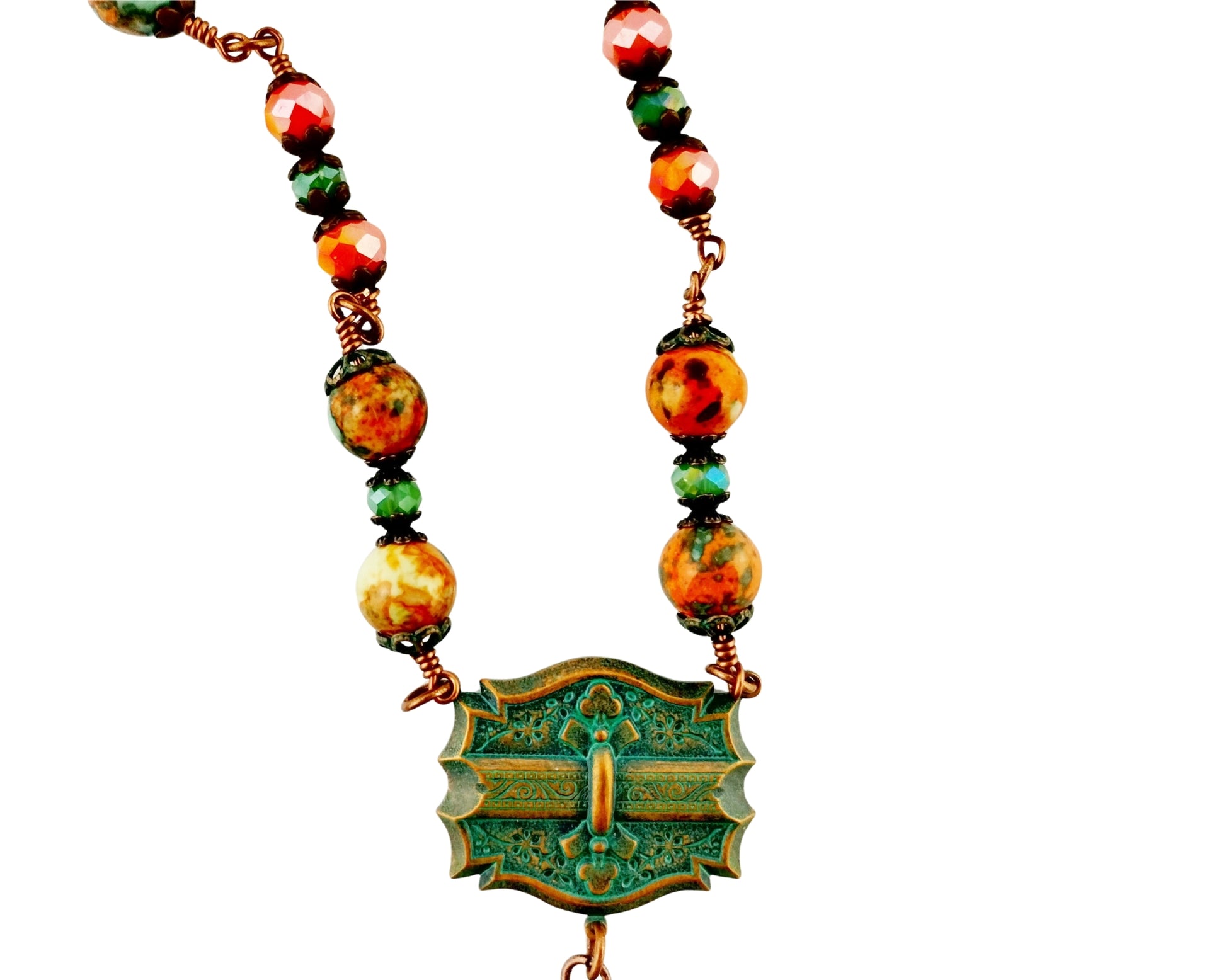 Colorful beaded necklace with a decorative green pendant on a white background