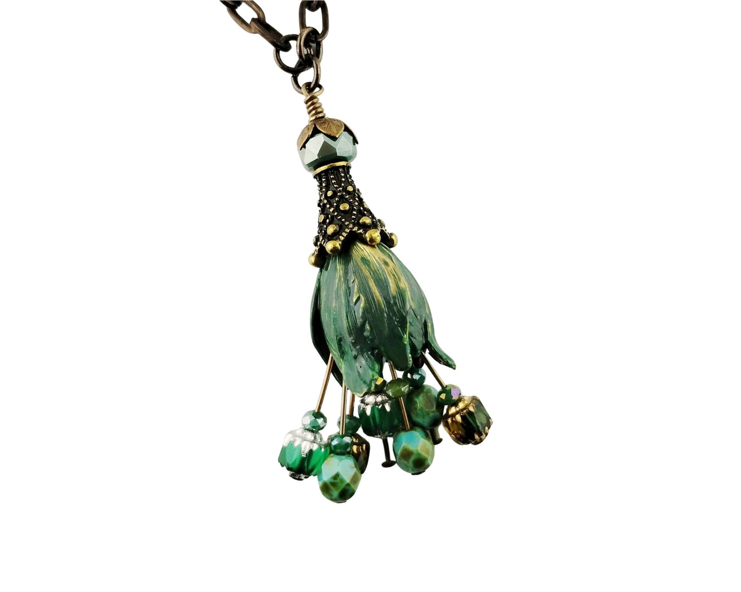 A green beaded pendant necklace featuring a textured green glass bead centerpiece, smaller green beads, and gold-toned accents, suspended from a dark metal chain against a white background.