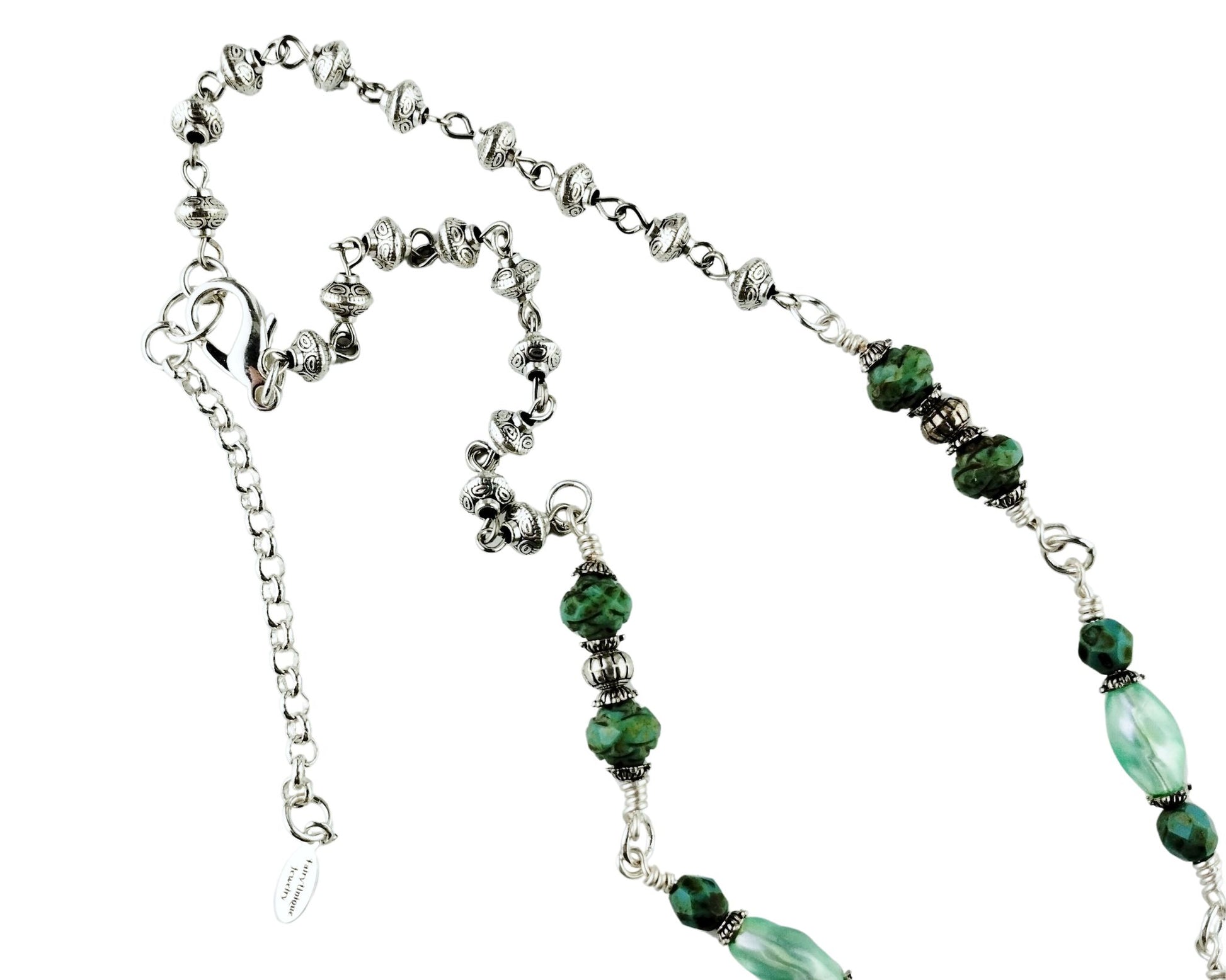 Close-up of green gemstone necklace with silver saucer bead chain